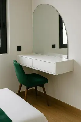 a bedroom with a green chair and a mirror at Appartement moderne Piscine, Wifi fibre, parking in Marrakech