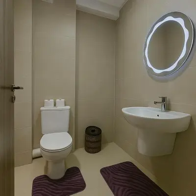 a bathroom with a toilet and a sink and a mirror at Appartement moderne Piscine, Wifi fibre, parking in Marrakech