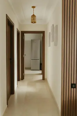 an empty hallway with a hallway leading into a room at Appartement moderne Piscine, Wifi fibre, parking in Marrakech