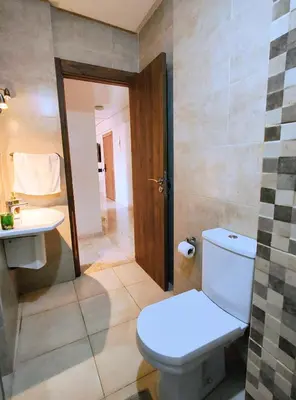 a bathroom with a toilet and a sink at Chic appartement à Gueliz Avec 2 chambres & piscine in Marrakech