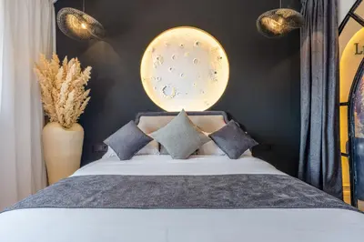 a bedroom with a large bed with pillows at LE MAJOREL Centre Marrakech in Marrakech