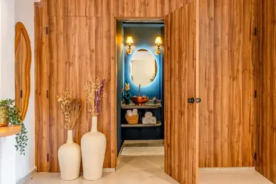 a hallway with two white vases and a mirror at LE MAJOREL Centre Marrakech in Marrakech