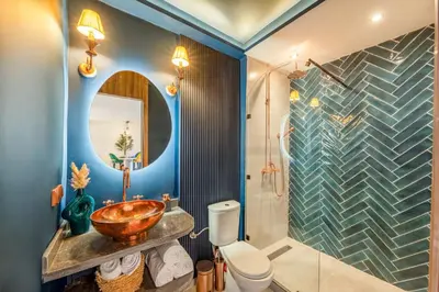 a bathroom with a sink and a toilet and a mirror at LE MAJOREL Centre Marrakech in Marrakech