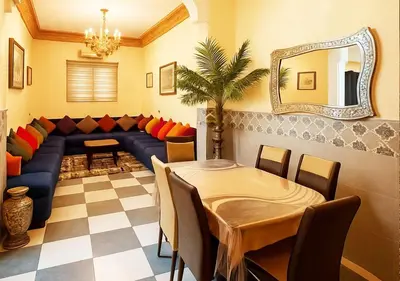 a living room with a couch and a table and a mirror at Appart Nour in Marrakech
