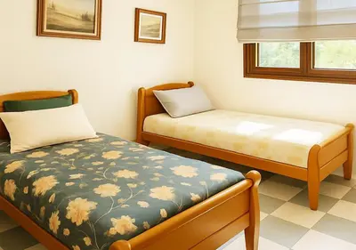 a small room with two beds and a window at Appart Nour in Marrakech