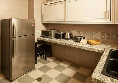 a kitchen with a stainless steel refrigerator and microwave at Appart Nour in Marrakech