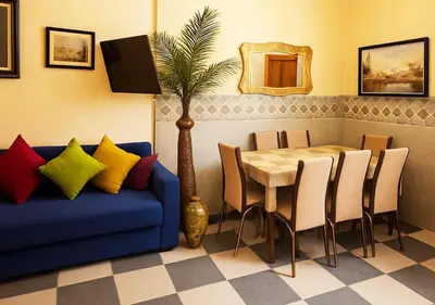 a dining room with a blue couch and a table at Appart Nour in Marrakech