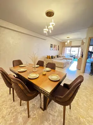 a dining room with a wooden table and chairs at Luxuriöse Wohnung mit Pool und Netflix in Marrakech