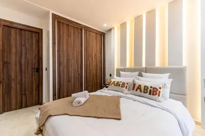 a bedroom with a large white bed with white pillows at Modern Apartment in Victor Hugo Walk to Gueliz City Center in Marrakech