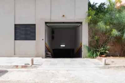 a door to a building with a garage at Modern Apartment in Victor Hugo Walk to Gueliz City Center in Marrakech