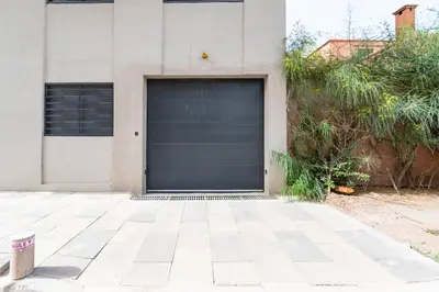 a garage door on the side of a house at Modern Apartment in Victor Hugo Walk to Gueliz City Center in Marrakech