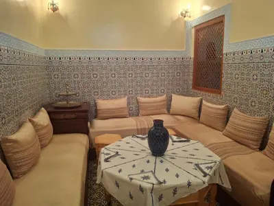 a living room with a couch and a vase on a table at Étoile de fatima - au cœur de la médina in Marrakech