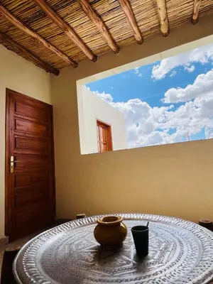 a room with a table with a bowl on it at Riad Émeraude Privé 3 chambres avec piscine Médina Marrakech in Marrakech