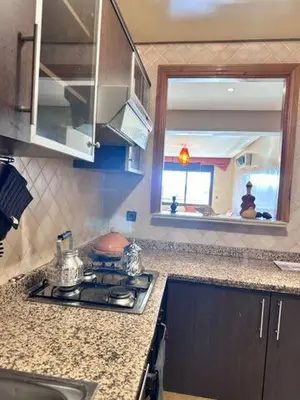 a kitchen counter with a stove and a sink at Central Gueliz Apartment Bright & Peaceful in Marrakech