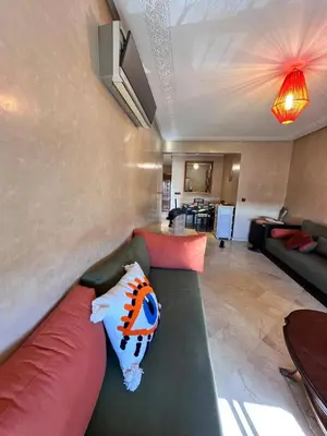 a living room with a couch with pillows on it at Central Gueliz Apartment Bright & Peaceful in Marrakech