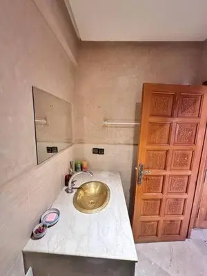 a bathroom with a gold sink on a counter at Central Gueliz Apartment Bright & Peaceful in Marrakech