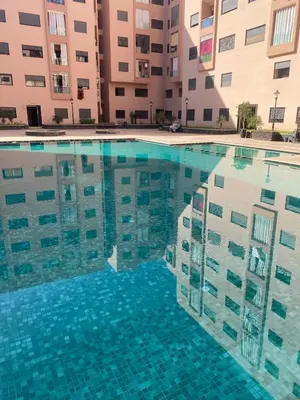 a swimming pool in front of a building at Chic Marrakech Getaway with Pool, Gym & Security in Marrakech