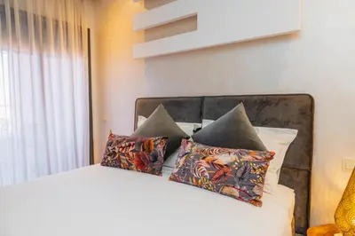 a bedroom with a white bed with pillows at Chic Marrakech Getaway with Pool, Gym & Security in Marrakech