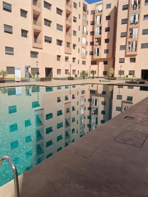 a swimming pool in front of a building at Chic Marrakech Getaway with Pool, Gym & Security in Marrakech