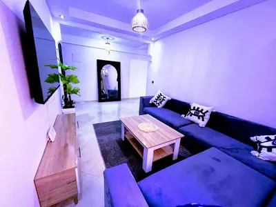 a living room with a blue couch and a table at مراكش سنتر جيليز احسن موقع في مراكش in Marrakech