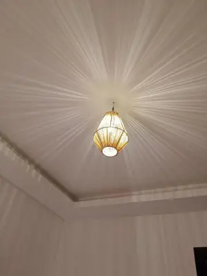 a light hanging from a ceiling in a room at مراكش سنتر جيليز احسن موقع في مراكش in Marrakech