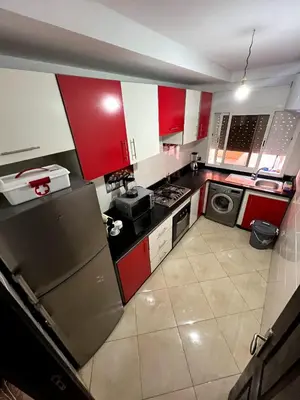 a kitchen with red and white cabinets and appliances at مراكش سنتر جيليز احسن موقع في مراكش in Marrakech