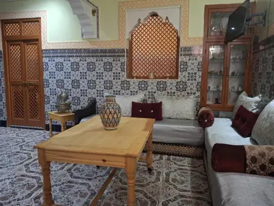 a living room with a couch and a table at Lalla Fatima - a deux pas de la Bahia in Marrakech