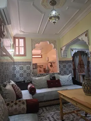 a living room with a couch and a table at Lalla Fatima - a deux pas de la Bahia in Marrakech