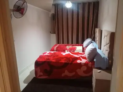a bedroom with a red bed with a red blanket at appartement marrakech Gueliz in Marrakech