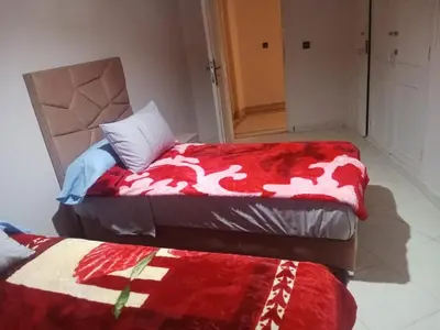 two beds sitting next to each other in a room at appartement marrakech Gueliz in Marrakech