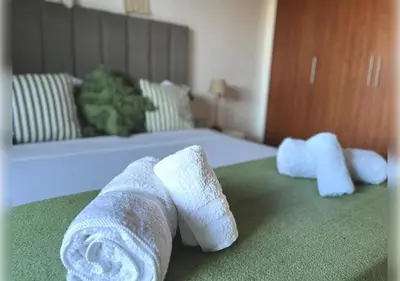 two rolls of towels on a bed in a room at Ehden Properties - Appt d'exception dans l'incontournable Prestigia in Marrakech