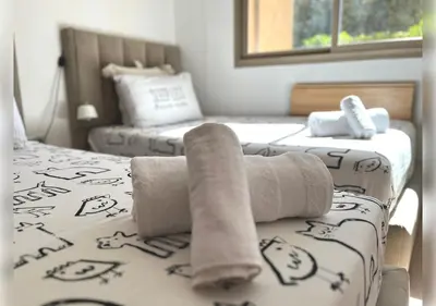 two beds in a room with towels on the bed at Ehden Properties - Appt d'exception dans l'incontournable Prestigia in Marrakech