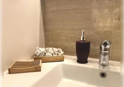 a bathroom sink with a faucet and a soap dispenser at Ehden Properties - Appt d'exception dans l'incontournable Prestigia in Marrakech