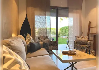 a living room with a couch and a table at Ehden Properties - Appt d'exception dans l'incontournable Prestigia in Marrakech