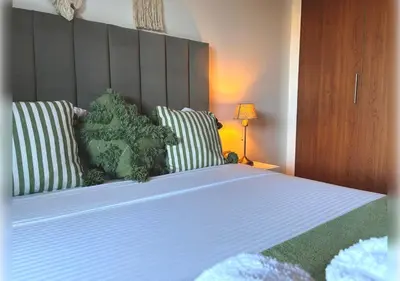 a bedroom with a large bed with two pillows at Ehden Properties - Appt d'exception dans l'incontournable Prestigia in Marrakech