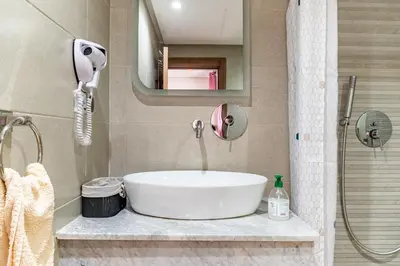 a bathroom with a white sink and a shower at 5 Star City Oasis Modern and Cozy in Marrakech