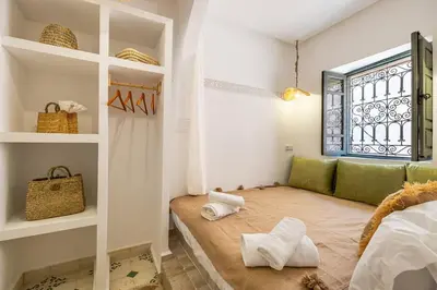 a room with a bed and a window and a couch at Riad Dar Mimouna -Exclusive&Brand new -Pool- 8pax in Marrakech