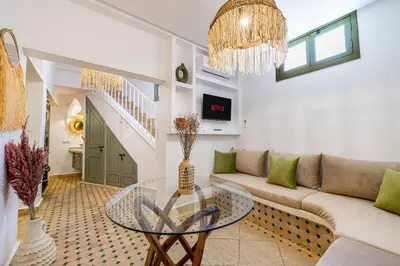 a living room with a couch and a glass table at Riad Dar Mimouna -Exclusive&Brand new -Pool- 8pax in Marrakech