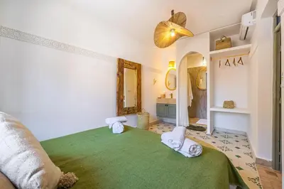 a room with a green rug and two towels at Riad Dar Mimouna -Exclusive&Brand new -Pool- 8pax in Marrakech