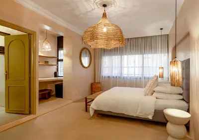 a bedroom with a white bed and a window at Apartment in Gueliz, Riad style, equipped and central in Marrakech