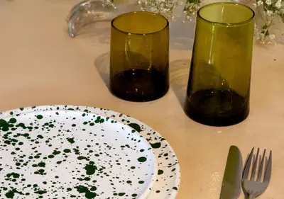 a table with a plate and two glasses and a fork at Apartment in Gueliz, Riad style, equipped and central in Marrakech