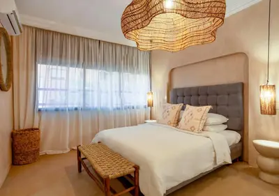 a bedroom with a large bed and a large window at Apartment in Gueliz, Riad style, equipped and central in Marrakech