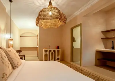 a bedroom with a bed and a chandelier at Apartment in Gueliz, Riad style, equipped and central in Marrakech