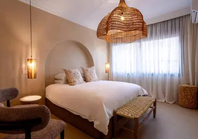 a bedroom with a bed and a large window at Appartement à Guéliz, style Riad, équipé & central in Marrakech