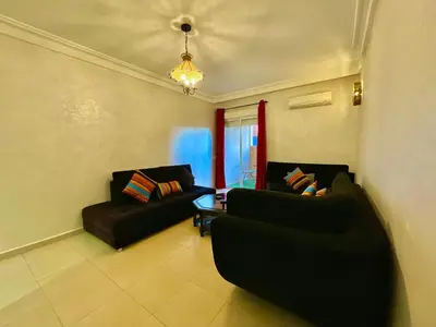 a living room with two black couches and a table at 5-Star Hidden Gem in Marrakech in Marrakech
