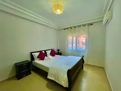 a bedroom with a large white bed with red pillows at 5-Star Hidden Gem in Marrakech in Marrakech