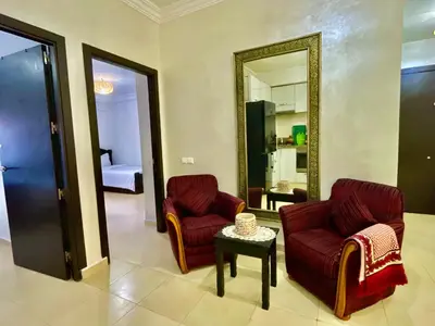 a living room with two chairs and a mirror at 5-Star Hidden Gem in Marrakech in Marrakech