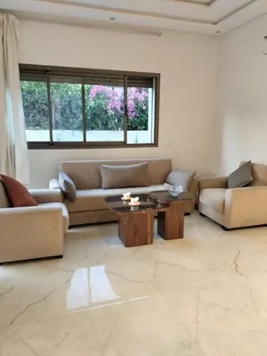 a living room with two couches and a table at Villa Moderne 5 chambres vue sur Atlas in Marrakech