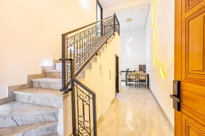 a staircase in a home with white walls at Duplex Confort, Jacuzzi à 5min de Majorelle&Médina in Marrakech