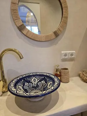 a bathroom sink with a large blue and white bowl at Dar laarbi Kasbah in Marrakech
